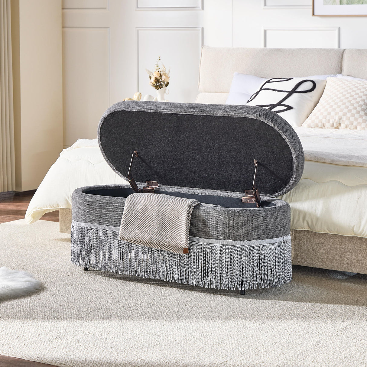 Oval Upholstered Storage Ottoman With Fringe Trim & Lift Top Lid